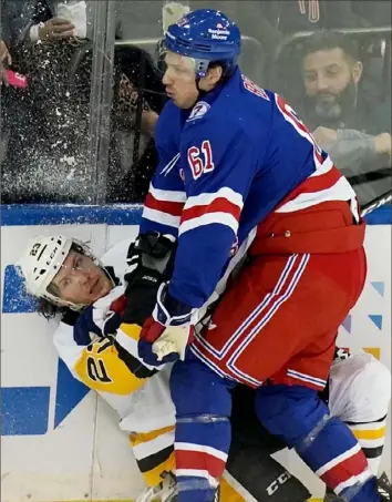  ?? Matt Freed/Post-Gazette ?? TANGLED UP IN BLUE Rangers defenseman Justin Braun hits Penguins winger Brock McGinn in the first period of Game 5 Wednesday night in New York.