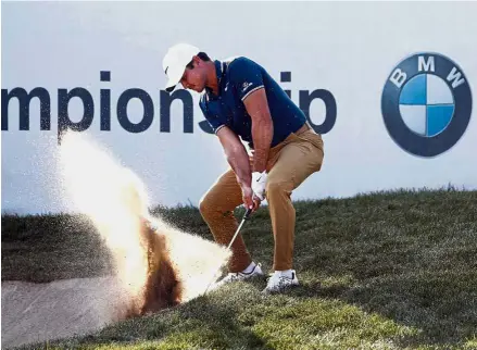  ?? — AP ?? Come out, you: Jason Day hitting out of a bunker shot from an awkward stance on the 18th hole during the third round of the BMW Championsh­ip on Saturday.