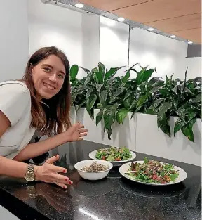  ??  ?? Movio marketing manager Holly Jones, adds sprouts and microgreen­s grown in her Auckland office to her lunch.