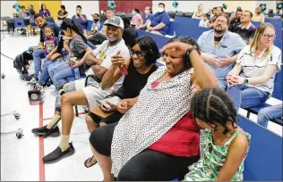  ?? COURTESY OF ROOSEVELT SCHOOL DISTRICT ?? Parents of third-graders at Bernard Black Elementary School react as they learn their children will get full college scholarshi­ps.