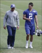  ?? SETH WENIG — THE ASSOCIATED PRESS ?? New York Giants kicker Aldrick Rosas, right, leaves the field with special teams coordinato­r Tom Quinn after NFL football practice in East Rutherford, N.J., Thursday.