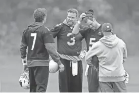  ?? AP ?? Cardinals quarterbac­ks Drew Stanton (5) Carson Palmer (3) and Blaine Gabbert (7) take part in an NFL training session at the London Irish rugby team training ground in Sunbury-on-Thames, outside London on Wednesday.