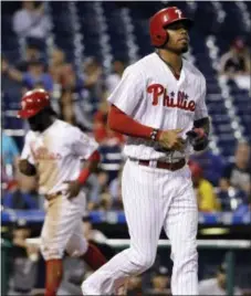  ?? THE ASSOCIATED PRESS — MATT SLOCUM ?? The Phillies Nick Williams, right, jogs to first base after being hit by a pitch in the third inning Tuesday, forcing home Odubel Herrera in a game the Philies would win, 9-8 in 15 innings. Manager Pete Mackanin hopes to see the outfield trio of...