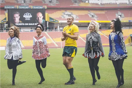  ?? Picture: AAP IMAGE ?? Reds giant Izack Rodda dances in the rain with Irish dancers (from left) Caitlin Gray, Sophie Liang, Chloe Peirce and Sharnae Harris.