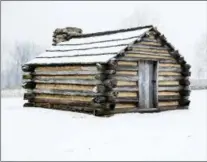  ??  ?? Snow covers a hut at Valley Forge National Historical Park in Valley Forge, one of many structures dating back to the Revolution­ary War.