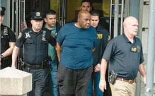  ?? ?? Frank James is walked from the 9th precinct in Manhattan on April 13. He was arrested after the NYPD received a tip when he was spotted on First Ave. near St. Marks Place.