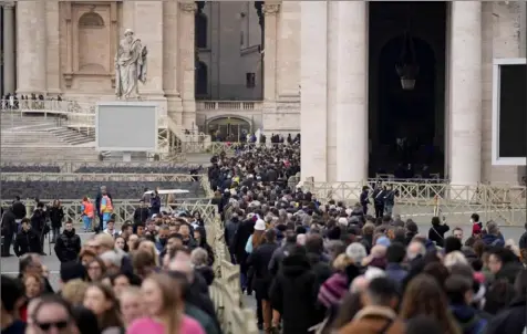  ?? Associated Press ?? People wait in a line Monday to enter Saint Peter's Basilica at the Vatican where the late Pope Emeritus Benedict XVI is being laid in state at The Vatican. His funeral is scheduled for Thursday morning.