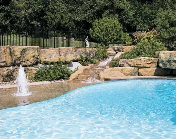  ?? Alex Driehaus/Post-Gazette photos ?? Kerry and Bill Boehner's pool is surrounded by their large garden in Mt. Lebanon.