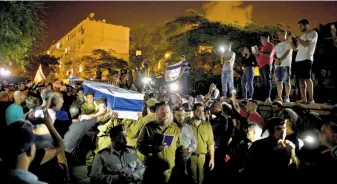  ?? Oded Balilty / Associated Press ?? Thousands attend the funeral for Sgt. Nissim Sean Carmeli of Texas in Haifa, Israel.