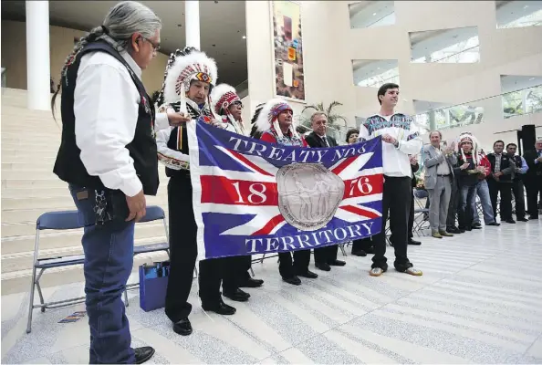  ?? FILES ?? Mayor Don Iveson, right side of flag, and a number of Treaty 6 chiefs hold up the Treaty 6 flag during the second annual Treaty 6 Day proclamati­on at City Hall back in 2014. Council voted Tuesday to fly the Treaty 6 and Métis flags at City Hall year-round.