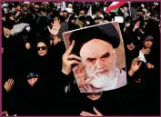  ?? ?? A progovernm­ent demonstrat­or holds a poster of the late Iranian revolution­ary founder Ayatollah Khomeini