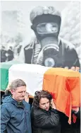  ??  ?? Bernadette McGuinness, right, bearing the coffin of her husband