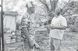  ?? James Nielsen / Houston Chronicle ?? Tres Davis, right, makes a pitch to Charles Randle while campaignin­g for a seat on Richmond’s city commission. The teacher wants to add more commission­ers.