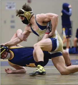  ?? AUSTIN HERTZOG - MEDIANEWS GROUP ?? Top, Spring-Ford senior Jack McGill is wearing the gold wrestling shoes of former teammate Louis Carbajal, who died last August in a car crash, this winter. Above, McGill takes down Upper Perkiomen’s Daniel Hawkins on the way to a first-period pin at 160 pounds on Feb. 15.