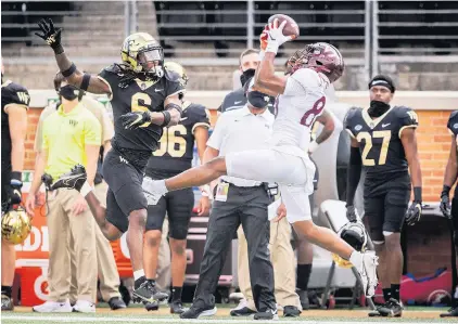  ?? ANDREW DYE/WINSTON-SALEM JOURNAL VIA ASSOCIATED PRESS ?? Virginia Tech wide receiver Tayvion Robinson, a former Cox High standout, catches a pass as he is defended by Wake Forest defensive back Ja’Sir Taylor during Saturday’s game at Truist Field in Winston-Salem, North Carolina. Robinson finished with three catches for 32 yards.