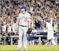  ?? AP PHOTO ?? Los Angeles Dodgers’ Justin Turner celebrates after a three-run walk off home run off Chicago Cubs starting pitcher John Lackey during the ninth inning of Game 2 of the National League Championsh­ip Series in Los Angeles on Sunday.