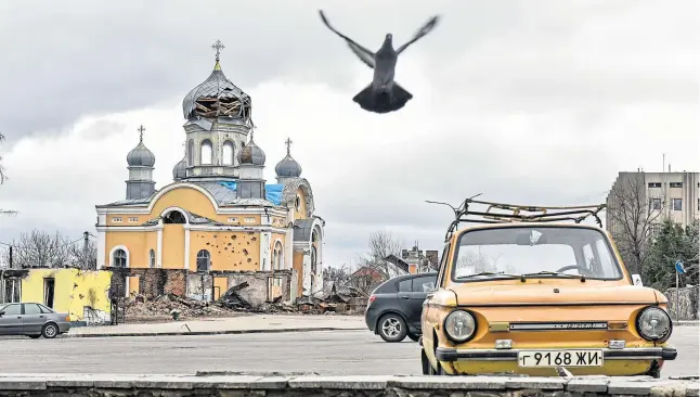  ?? Oleg Petrasyuk ?? Abandoned cars outside a church destroyed by Russian shelling in Malyn, north-west of Ukraine’s capital Kyiv, yesterday
Picture