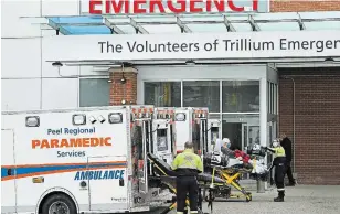  ?? NATHAN DENETTE THE CANADIAN PRESS ?? Paramedics transport an elderly man to a hospital’s emergency department in Mississaug­a Thursday. All regions of the province are reporting a rise in hospital admissions.