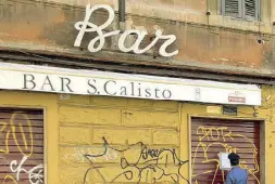  ??  ?? Trastevere L’entrata, con saracinesc­he abbassate, del bar a San Callisto