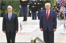  ?? Nicholas Kamm / AFP / Getty Images ?? Vice President Mike Pence (left) and President Trump honor fallen service members at the Tomb of the Unknown Soldier at Arlington National Cemetery.