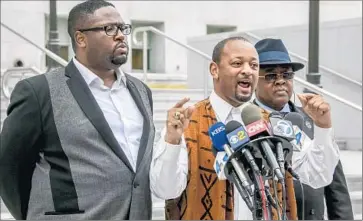  ?? Irfan Khan Los Angeles Times ?? THE REV. K.W. Tulles, left, Najee Ali, center, and the Rev. N.W. Martin hold a news conference urging Dist. Atty. Jackie Lacey to charge an LAPD officer in the Ezell Ford killing.