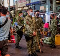  ?? PHOTOGRAPH BY RIO LEONELLE I. DELUVIO FOR THE DAILY TRIBUNE @tribunephl_rio ?? POLICEMEN are still in patrol, roaming around Marikina Public Market to remind the market-goers to follow health and safety protocols as there is still increasing Covid-19 cases in the country.