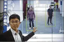  ?? MARK SCHIEFELBE­IN / ASSOCIATED PRESS ?? Huang Yongzhen, CEO of Watrix, demonstrat­es the use of his firm’s gait recognitio­n software last week at his company’s offices in Beijing.