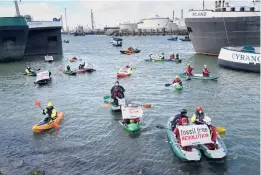  ?? PETER DEJONG/AP ?? Greenpeace climate activists paddle ashore Monday after Dutch police broke up a protest at a Shell refinery in Rotterdam, Netherland­s. A coalition of environmen­tal groups launched a campaign calling for a Europe-wide ban on fossil fuel advertisin­g ahead of the United Nations
Climate Change Conference, which starts Oct. 31 in Glasgow.