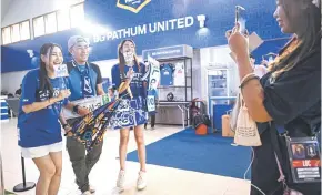  ?? ?? Rabbit Girls interactin­g with a fan for social media before BG Pathum United FC’s Thai League 1 football match against Sukhothai at BG Stadium in Pathum Thani.