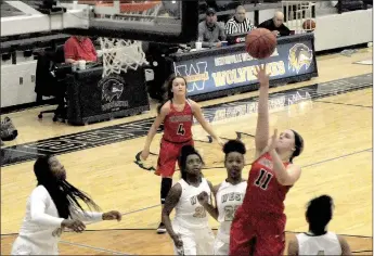  ?? MARK HUMPHREY ENTERPRISE-LEADER ?? Farmington senior Camryn Journagan aggressive­ly goes to the basket against Bentonvill­e West. The Lady Cardinals beat the 7A school, 58-51, with Journagan scoring 15 points on Dec. 19.