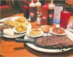  ?? PHOTO BY BEN BENTON ?? Bones’ Smokehouse’s combinatio­n platter, at left, includes Texas toast, dry-rubbed St. Louis-style ribs, smoked turkey, pulled pork, french fries and fried okra for $12.95. At right, a rib platter comes with a half-rack of dry-rubbed St. Louis-style...