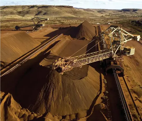  ?? Picture: AFP ?? DIGGING DEEP: Rio Tinto loading iron ore on a conveyor in the Pilbara in Western Australia – new research has shown the tax take from Australia’s mining companies has hit its highest level since the mining boom.