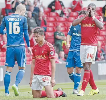  ??  ?? DESPAIR: Kyle Ebecilio holds his hands to his head as Forest slump to defeat