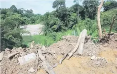  ??  ?? Rocks and soil from constructi­on sites being dumped at the ravine. — Bernama photo