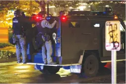  ?? (Lindsey Wasson/Reuters) ?? SEATTLE POLICE OFFICERS stand on the back of a vehicle during a protest march in the city year.