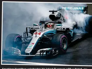  ?? REX ?? Smoking: Hamilton celebrates his latest F1 crownwithc­rownwith a donut