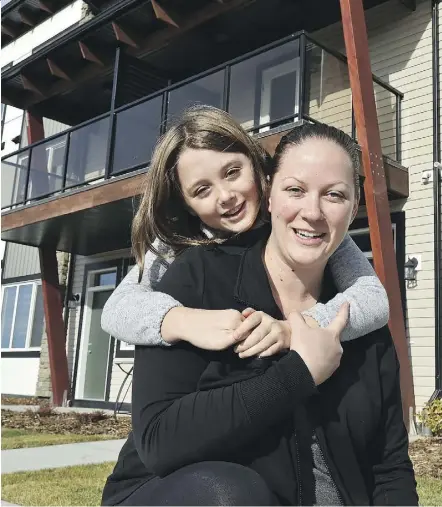  ?? ED KAISER/POSTMEDIA ?? Jenna and her daughter Anabelle, 9, received the keys to the first home from Habitat for Humanity’s Carter Work Project.