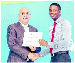  ?? CONTRIBUTE­D ?? President and CEO, Sagicor Group Jamaica, Christophe­r Zacca (left), presents an award certificat­e to Jevaughn Gordon, 2019 scholarshi­p recipient.