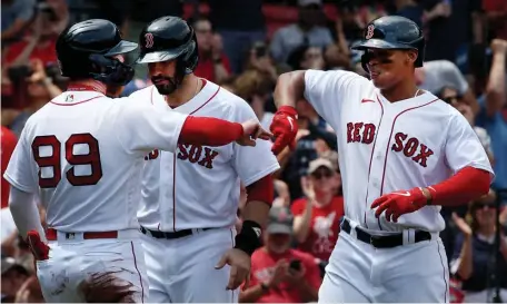  ?? NAncy LAnE / HERALd STAff ?? SMASHING SUCCESS: Red Sox slugger Rafael Devers, right, celebrates with teammates Alex Verdugo and J.D. Martinez after launching a 451-foot bomb in the first inning against the Yankees on Sunday.