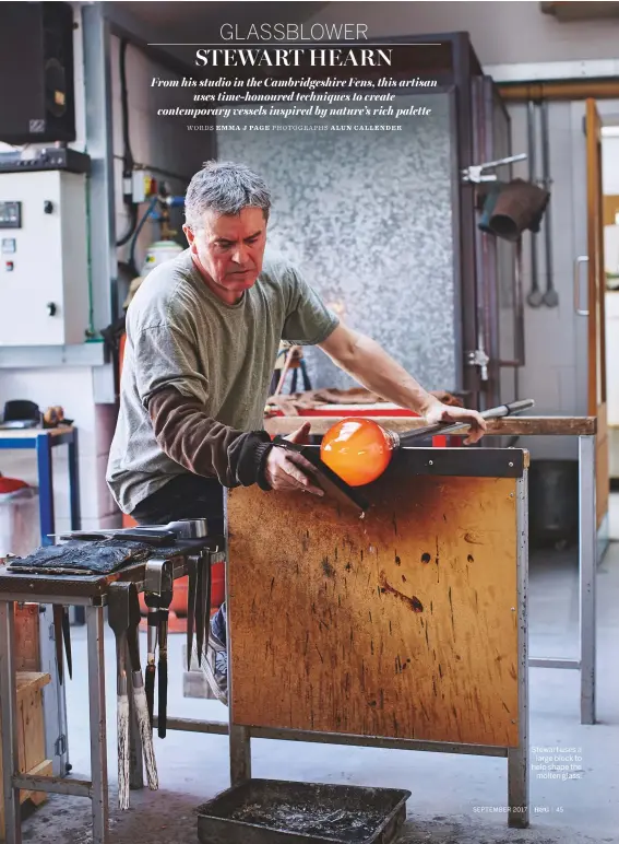  ?? PHOTOGRAPH­S ALUN CALLENDER ?? Stewart uses a large block to help shape the molten glass.