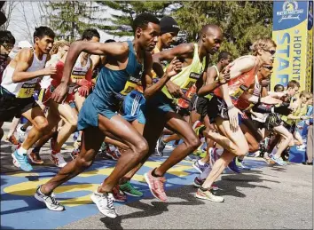  ?? Stephan Savoia / AP ?? Elite runners leave the start line in the 118th running of the Boston Marathon Monday, April 21, 2014 in Hopkinton, Mass.