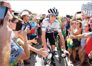  ?? JOSE JORDAN / AFP ?? Sky’s British cyclist Christophe­r Froome rides past fans before the start of the 17th stage of the 71st edition of ‘La Vuelta’ Tour of Spain on September 7.
