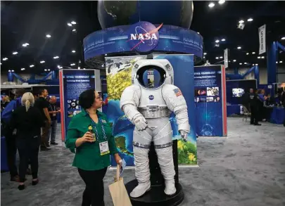  ?? Mark Mulligan photos / Houston Chronicle ?? Visitors explore the exhibit floor this week at the Space Commerce Conference and Exposition downtown.