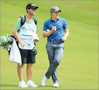  ??  ?? Wicklow’s Paul Dunne looks down the 4th hole with caddie Darren Reynolds during day four of the BMW PGA Championsh­ip at Wentworth.