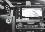  ??  ?? Backup cameras, such as this one in the dashboard of a 2017 Honda Civic, will be required on most new vehicles beginning May 1.
