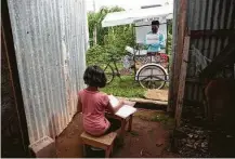  ?? Moises Castillo / Associated Press ?? Gerardo Ixcoy teaches student Paola Ximena Conoz, 12, from his mobile classroom in Santa Cruz del Quiche, Guatemala.