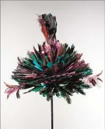  ??  ?? FEATHER HAT (straw with purple and green feathers).