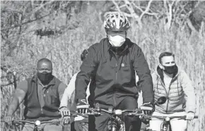  ?? JIM WATSON/AFP VIA GETTY IMAGES ?? President-elect Joe Biden rides his bike at Cape Henlopen State Park near Rehoboth Beach, Del., on Saturday.