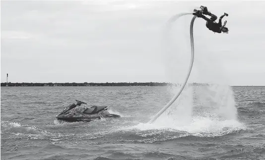  ?? TYLER BROWNBRIDG­E/The Windsor Star ?? Casey Lentsch demonstrat­es a flyboard on Lake St. Clair near Windsor Thursday. Such activities are restricted in waters of the Windsor Port Authority.