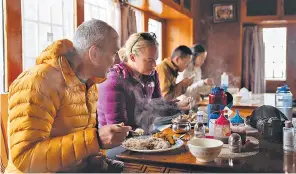  ?? ?? Haute cuisine: Dan and Lucy’s group tuck into dal bhat at Friendship Lodge & Restaurant in Thangnag